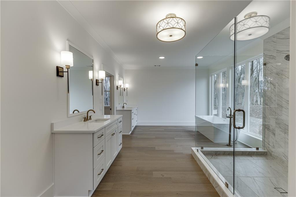 100 Gleneagles Way Pendergrass, GA 30567 - Photo 50 of 58 a bathroom with a double vanity sink a mirror and a shower