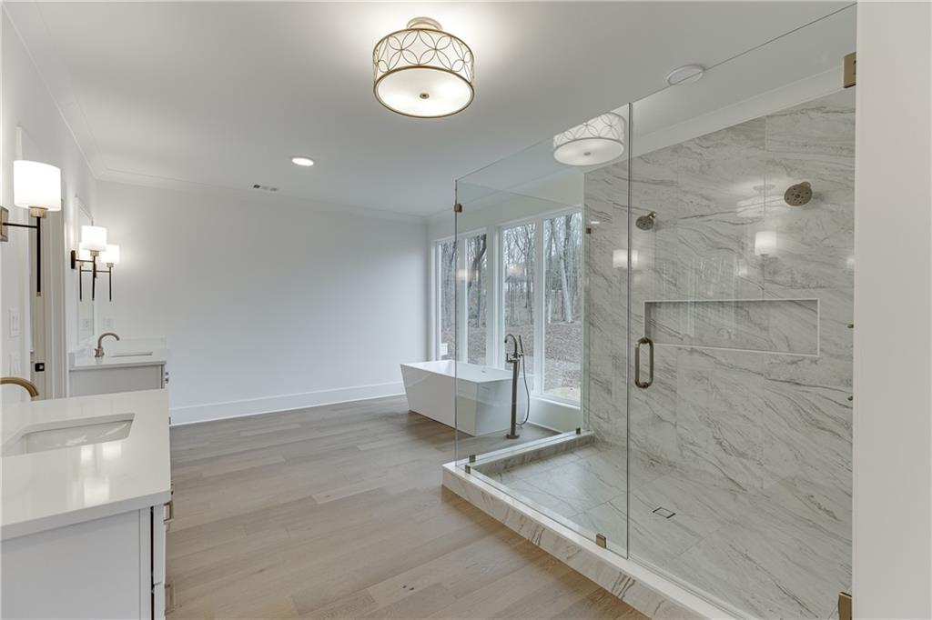 100 Gleneagles Way Pendergrass, GA 30567 - Photo 51 of 58 a bathroom with a double vanity sink mirror and shower