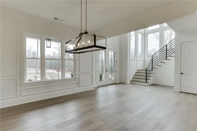 a kitchen with stainless steel appliances granite countertop a sink a stove and a wooden floors