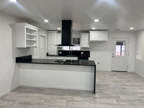 a kitchen with stainless steel appliances granite countertop a stove a sink and a refrigerator