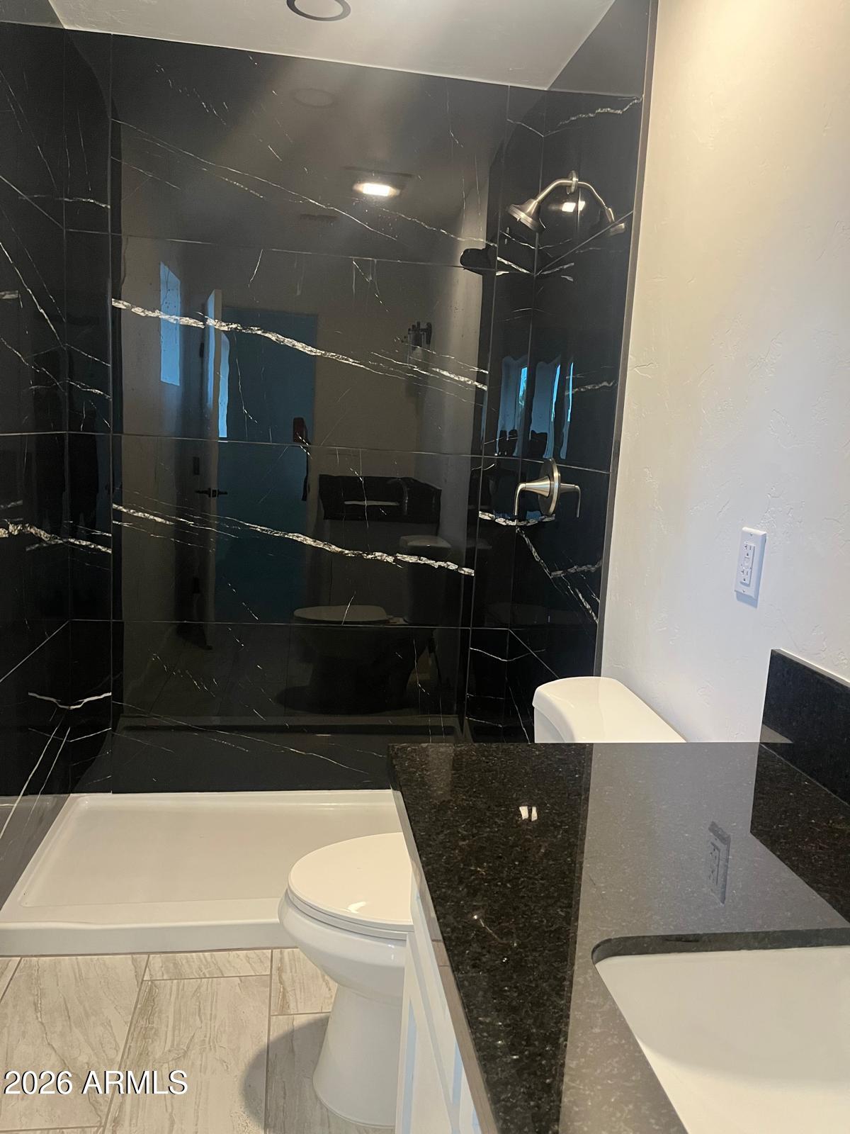 2435 East 13th Street Douglas, AZ 85607 - Photo 7 of 7 a bathroom with a toilet a sink and mirror