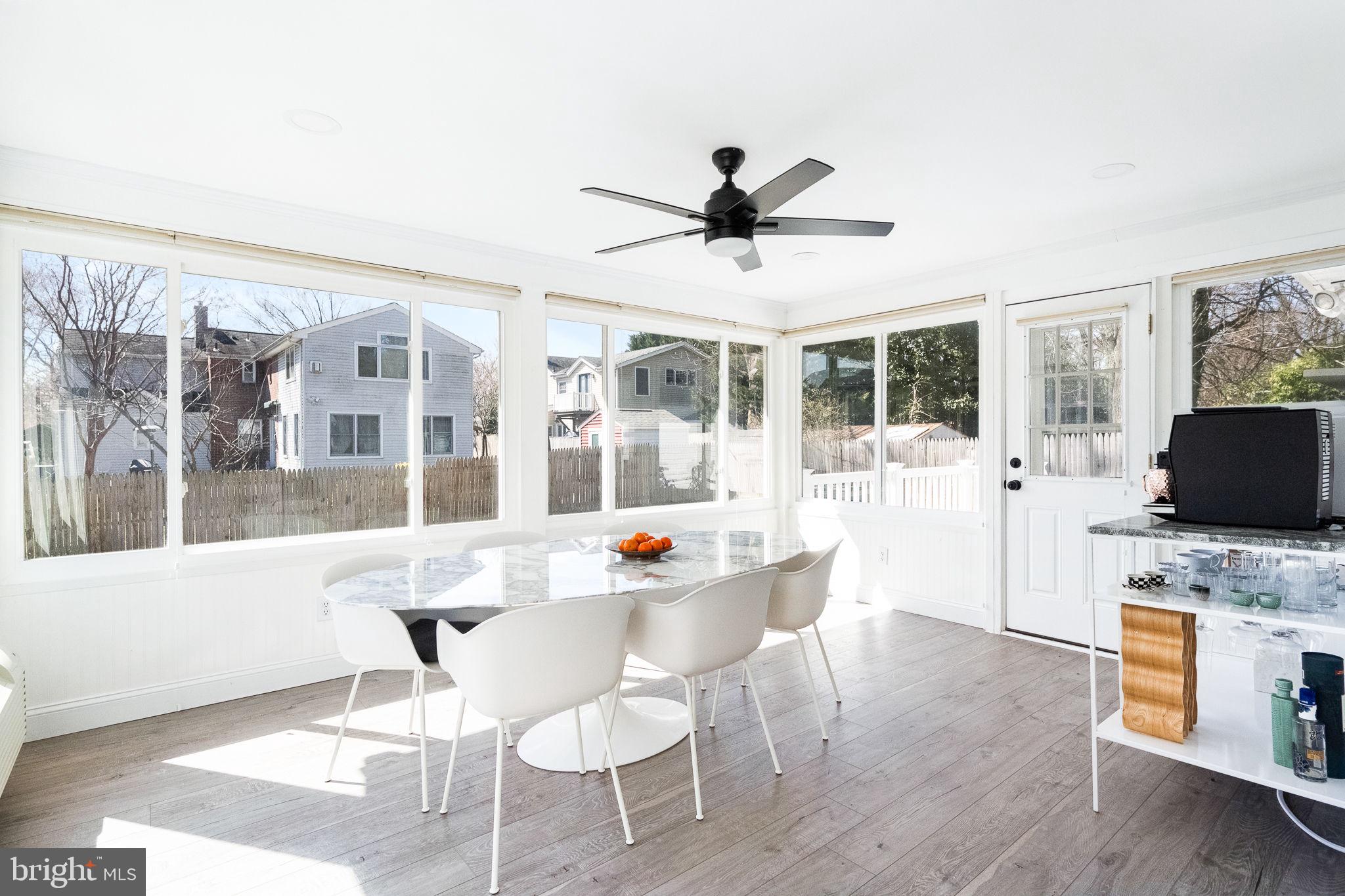 5020 River Road Bethesda, MD 20816 - Photo 13 of 36 a dining room with wooden floor and a chandelier