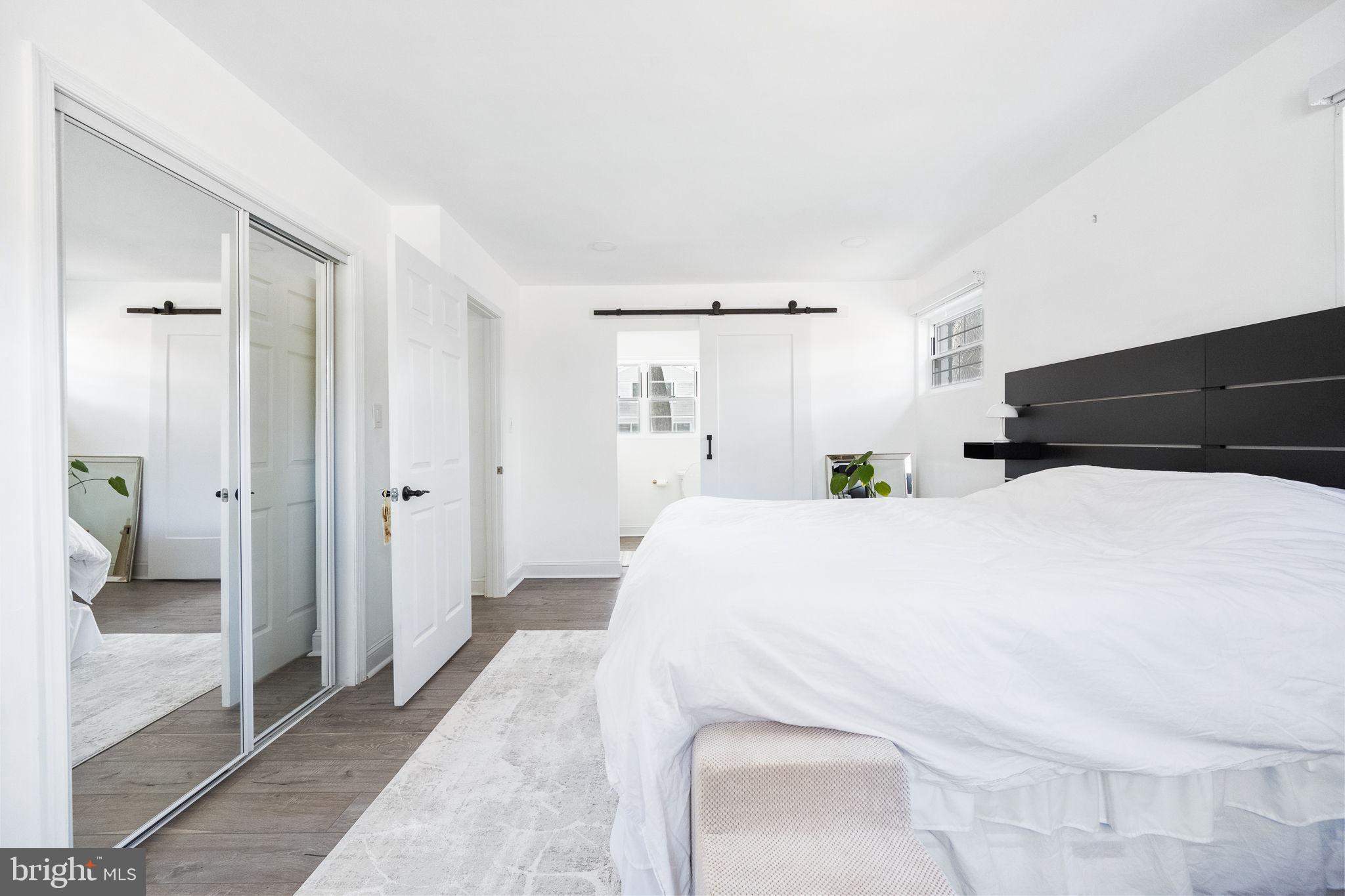 5020 River Road Bethesda, MD 20816 - Photo 15 of 36 a large white bed in a white room