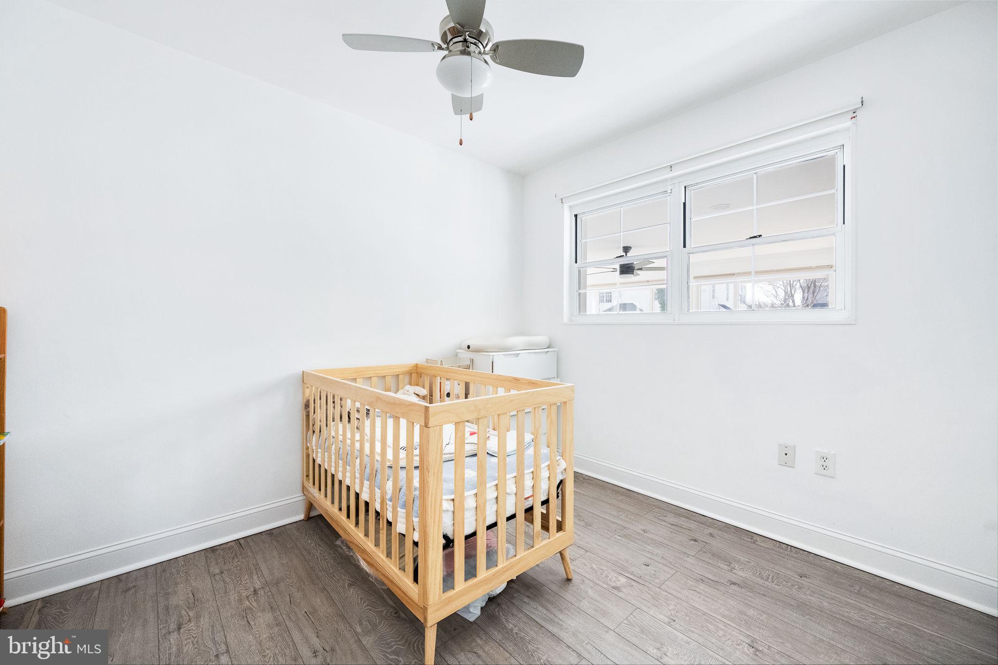 5020 River Road Bethesda, MD 20816 - Photo 24 of 36 a bedroom with a bed and wooden floor