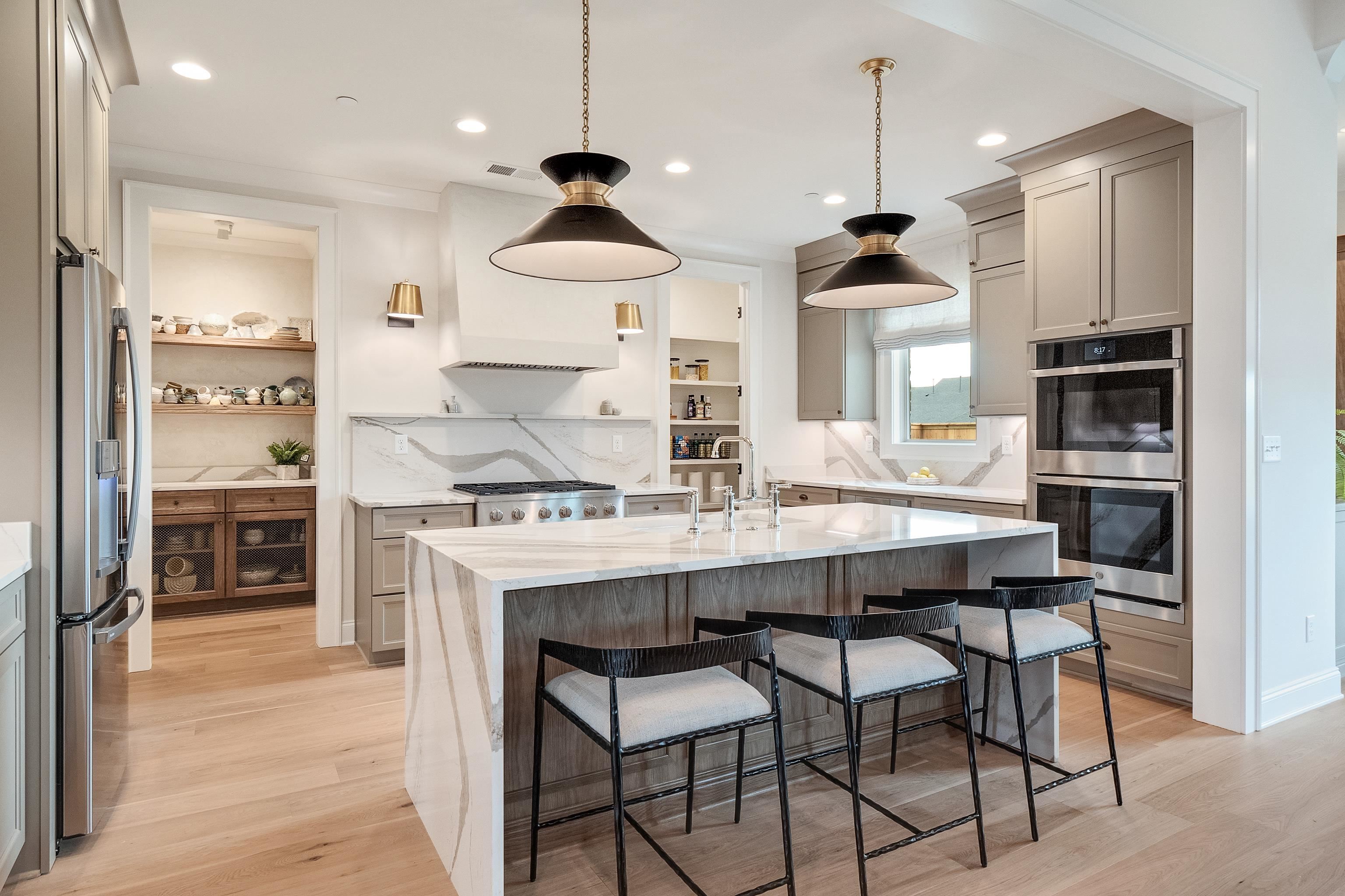 760 Cardinal Cove Collierville, TN 38017 - Photo 12 of 40 a kitchen with kitchen island granite countertop a sink a center island and stainless steel appliances