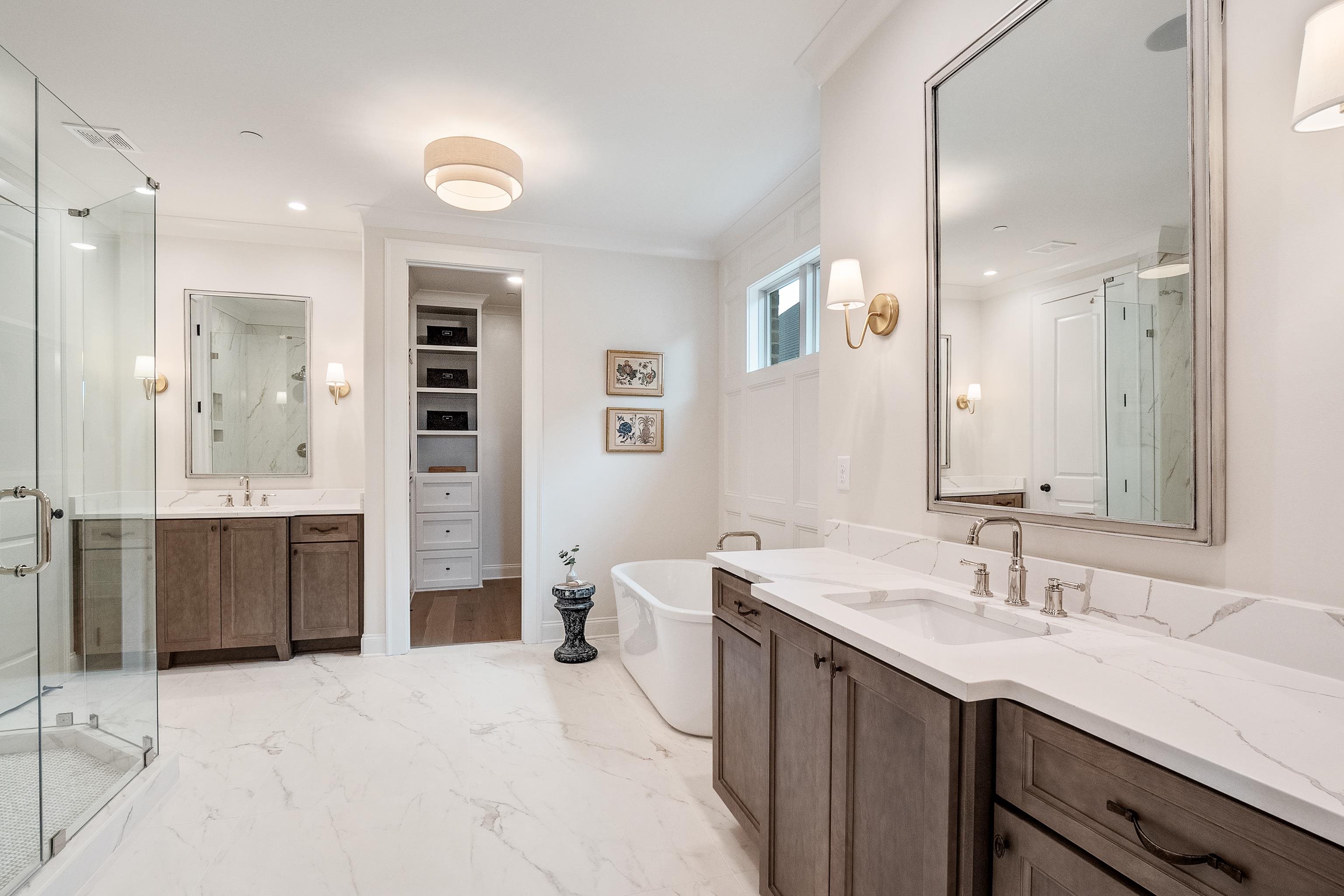 760 Cardinal Cove Collierville, TN 38017 - Photo 22 of 40 a spacious bathroom with a shower sink double vanity and mirror