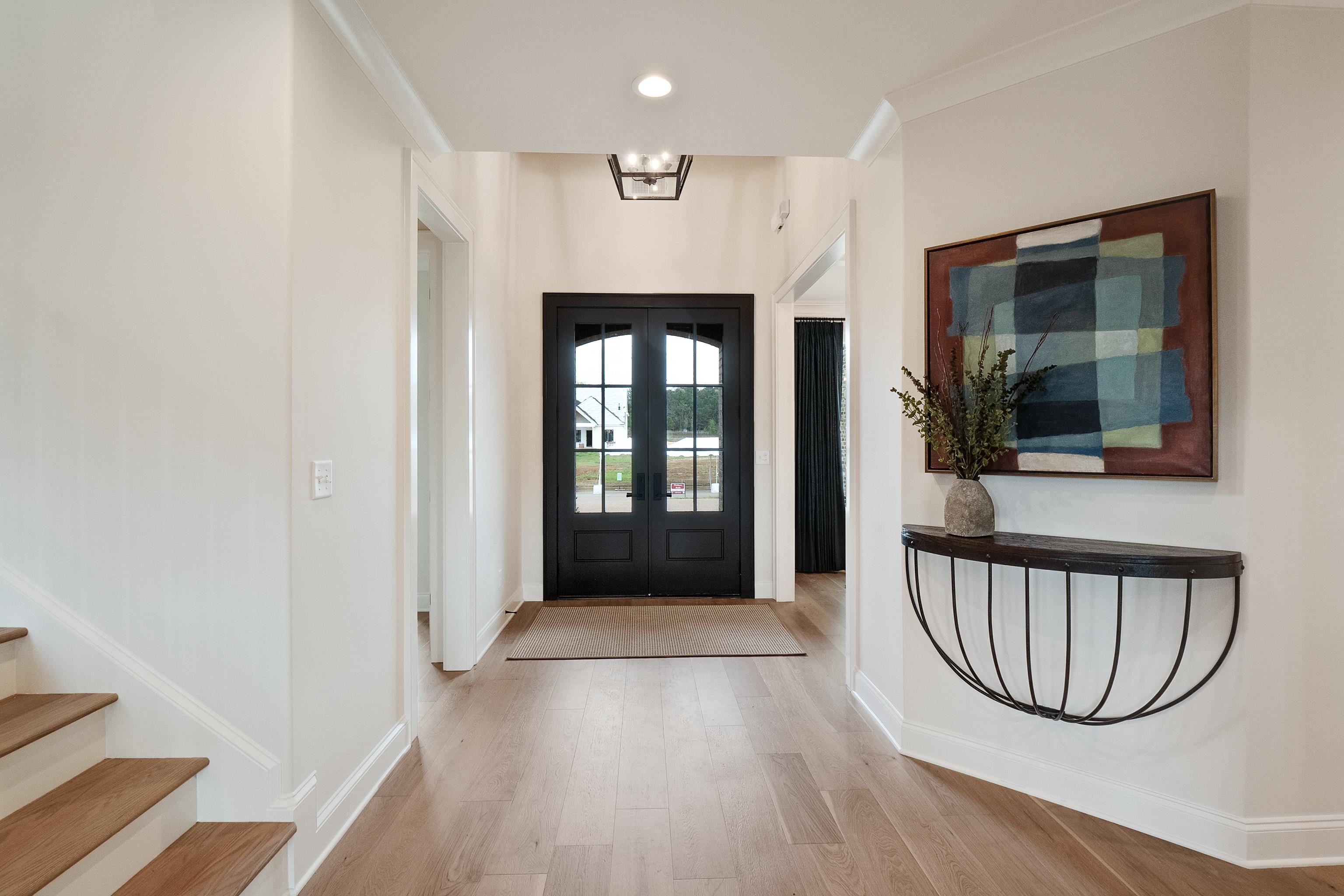 760 Cardinal Cove Collierville, TN 38017 - Photo 3 of 40 a view of a hallway with wooden floor and windows