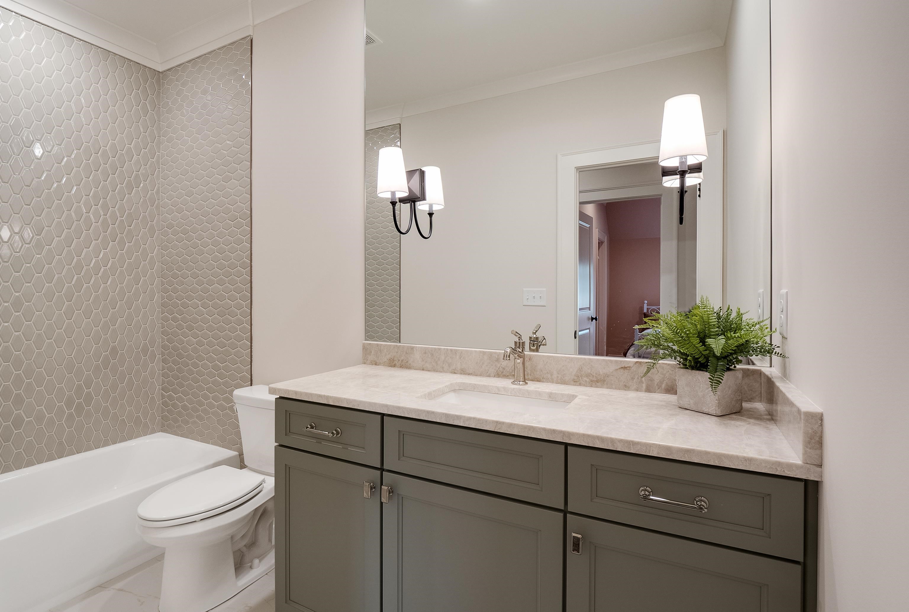 760 Cardinal Cove Collierville, TN 38017 - Photo 34 of 40 a bathroom with a sink a toilet and mirror