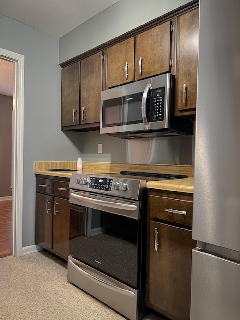 7935 Memphis Arlington Road Bartlett, TN 38133 - Photo 3 of 20 Kitchen featuring dark wood cabinetry, stainless steel range, and over-the-range microwave
