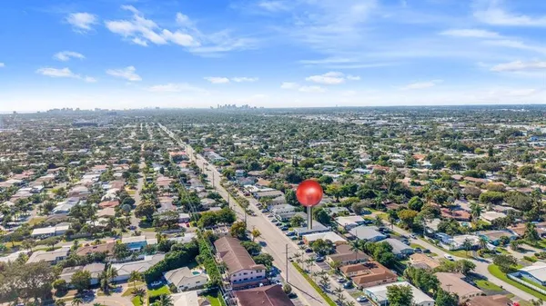 an aerial view of a residential houses with city view