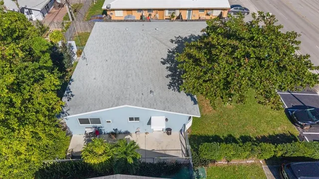 an aerial view of a house with a yard and garden