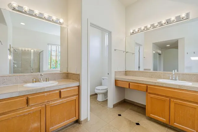 a spacious bathroom with sink shower bathtub and window