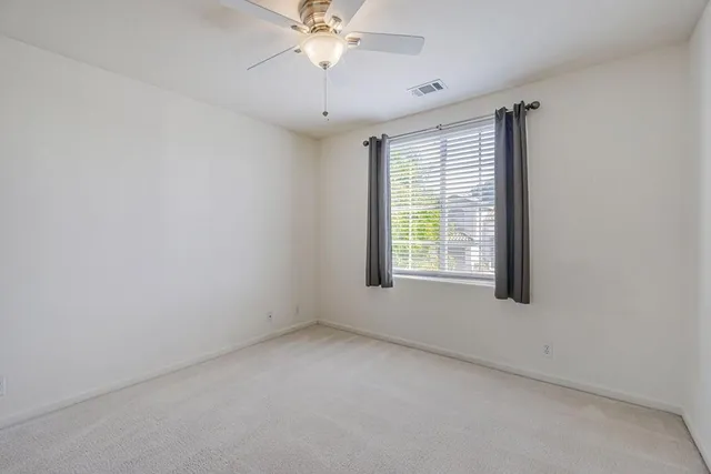 a bedroom with bed and a potted plant