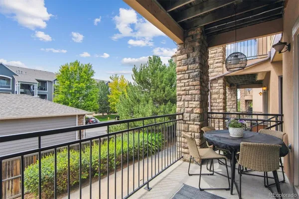 a view of a chairs and table in the balcony