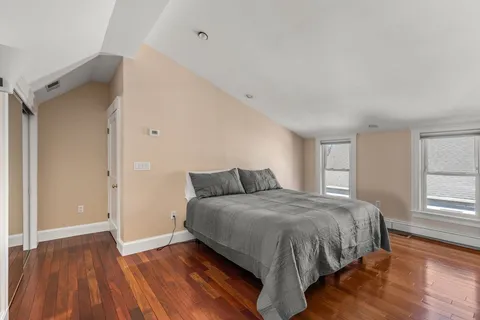 a bedroom with a bed and window