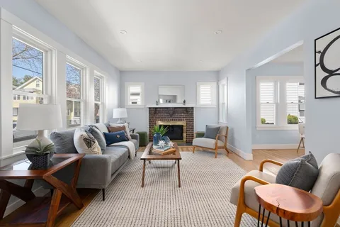 a living room with furniture and a fireplace