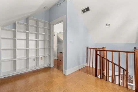 a view of an empty room with a staircase