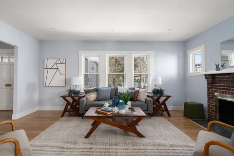 a living room with furniture a rug and a fireplace