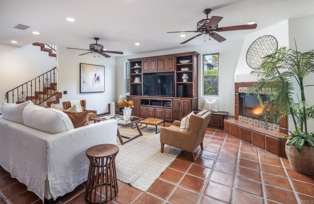 1133 Hermes Avenue Encinitas, CA 92024 - Photo 14 of 40 a living room with furniture a flat screen tv and a fireplace