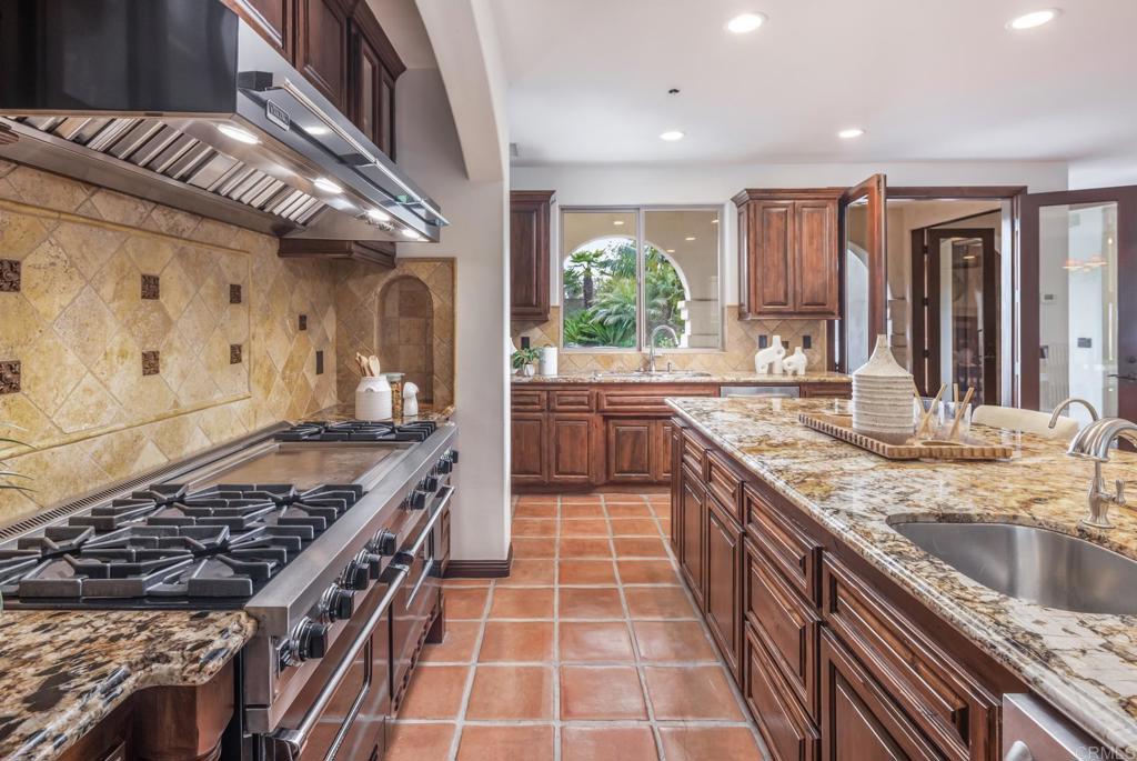 1133 Hermes Avenue Encinitas, CA 92024 - Photo 17 of 40 a large kitchen with stainless steel appliances granite countertop a large stove a sink and a granite counter tops