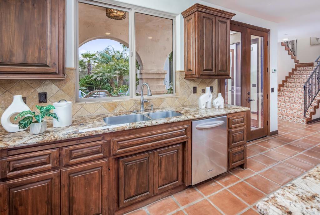 1133 Hermes Avenue Encinitas, CA 92024 - Photo 18 of 40 a kitchen with stainless steel appliances granite countertop a sink stove and cabinets