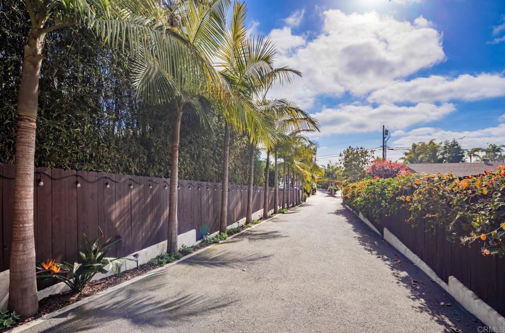 1133 Hermes Avenue Encinitas, CA 92024 - Photo 39 of 40 a view of a pathway with a wrought fence next to a yard