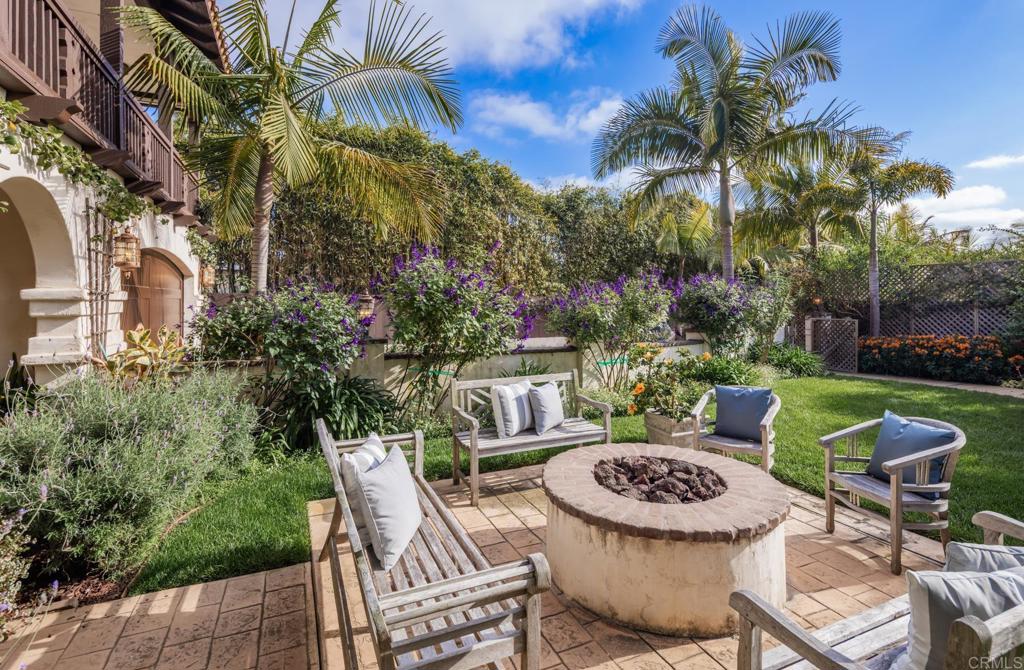 1133 Hermes Avenue Encinitas, CA 92024 - Photo 9 of 40 a view of a chairs and table in backyard of a house