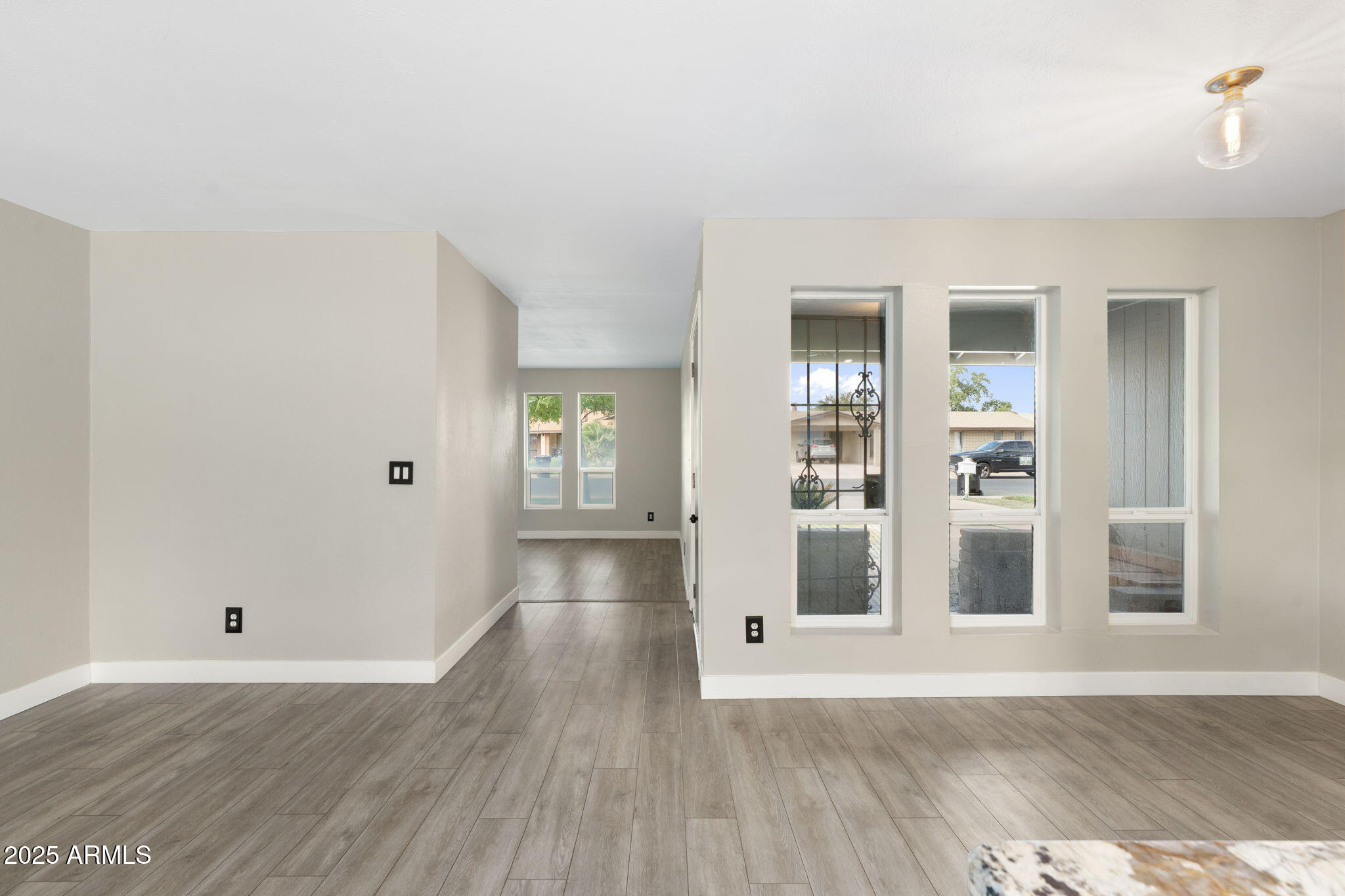 17 South Cholla Street Gilbert, AZ 85233 - Photo 15 of 37 an empty room with wooden floor and windows