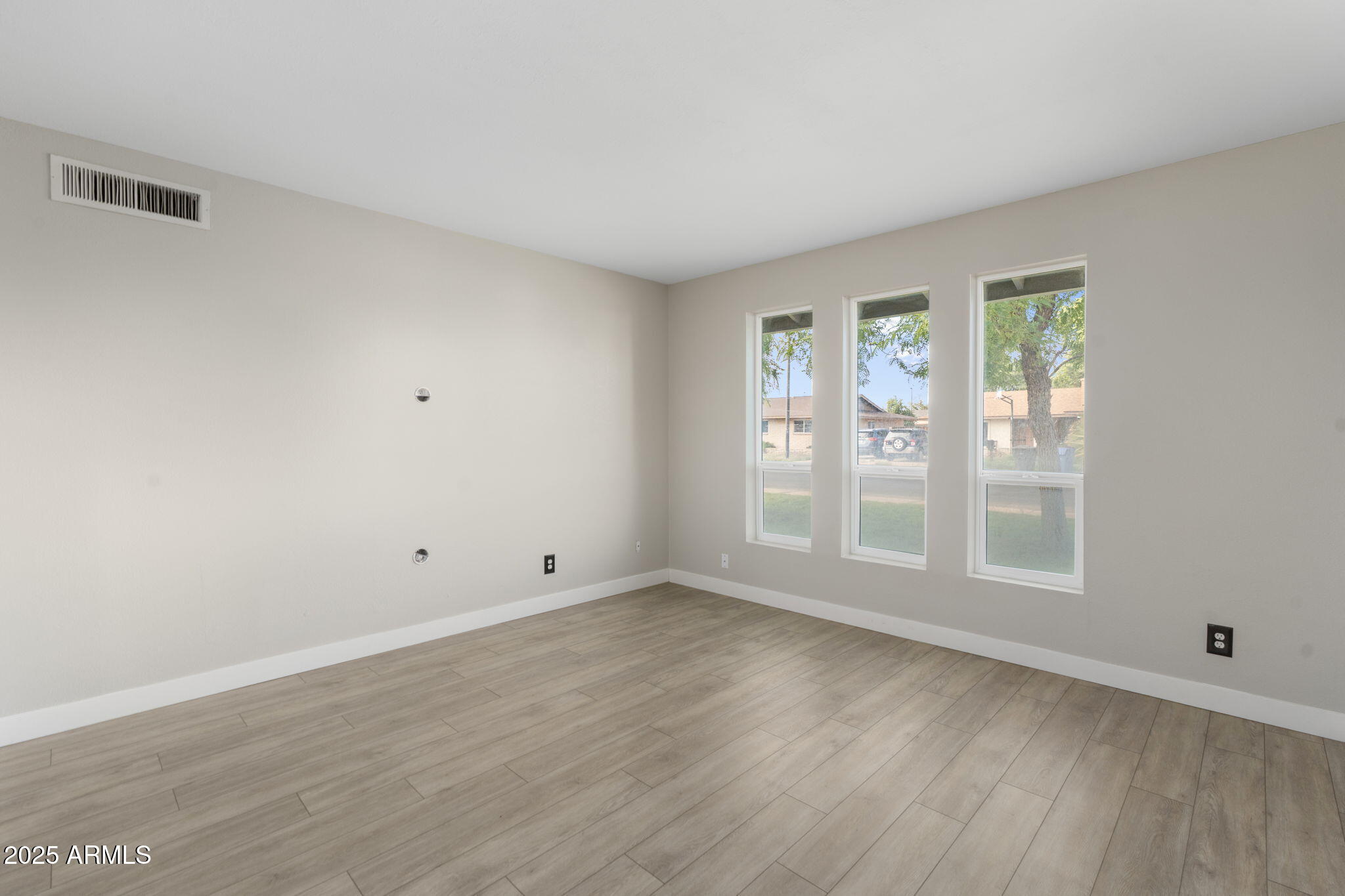 17 South Cholla Street Gilbert, AZ 85233 - Photo 18 of 37 an empty room with wooden floor and windows