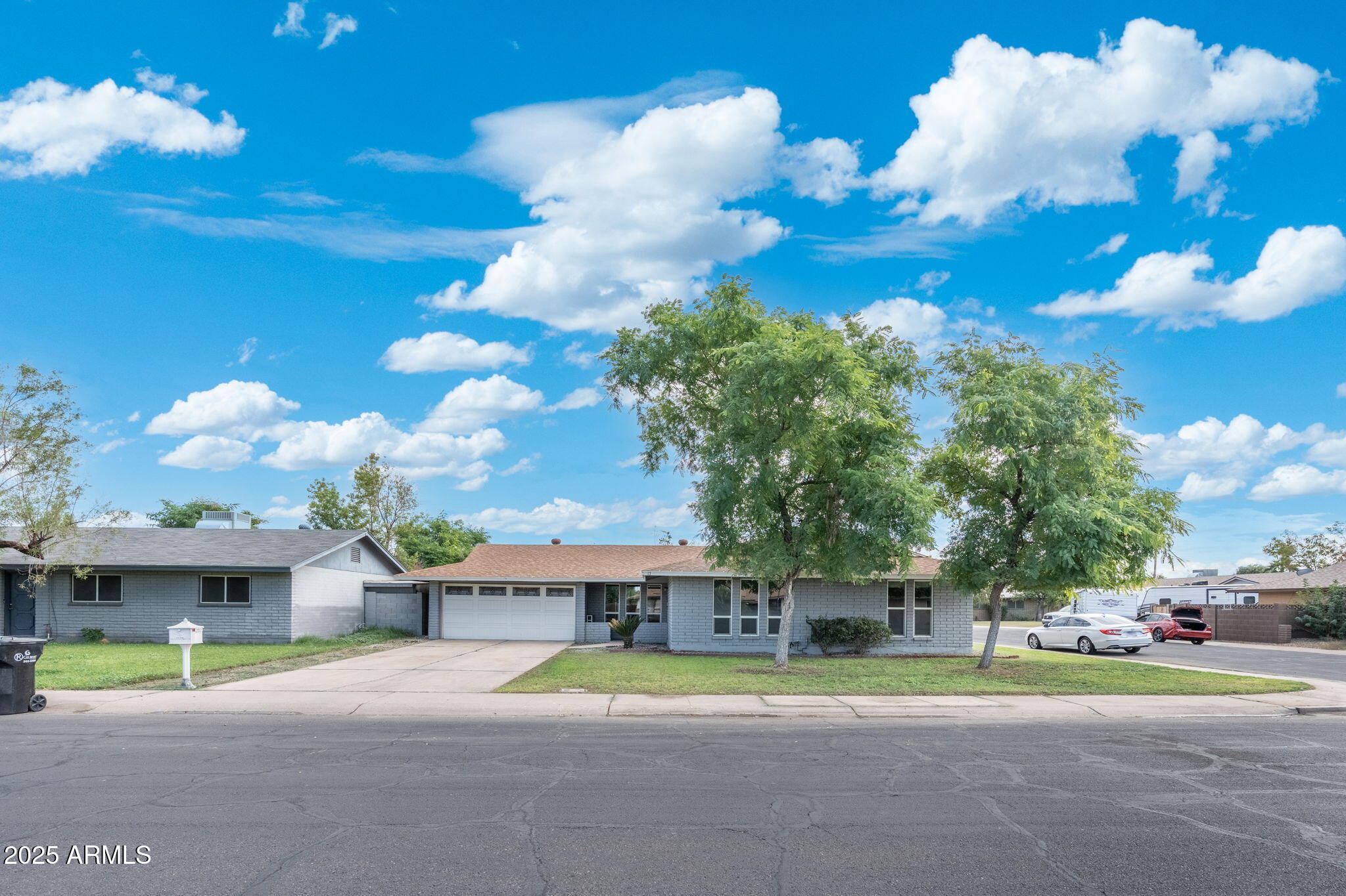 17 South Cholla Street Gilbert, AZ 85233 - Photo 2 of 37 a yellow house with trees in front of it