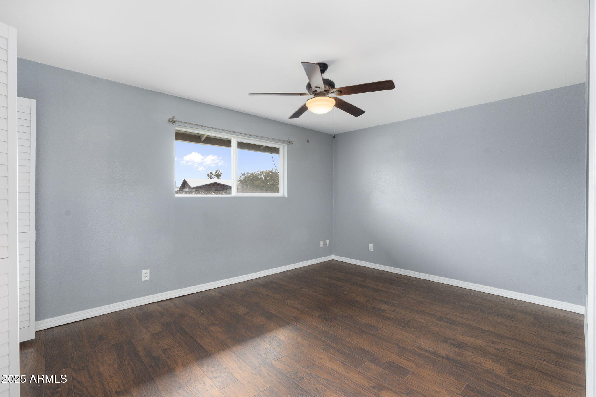 17 South Cholla Street Gilbert, AZ 85233 - Photo 22 of 37 an empty room with wooden floor fan and windows