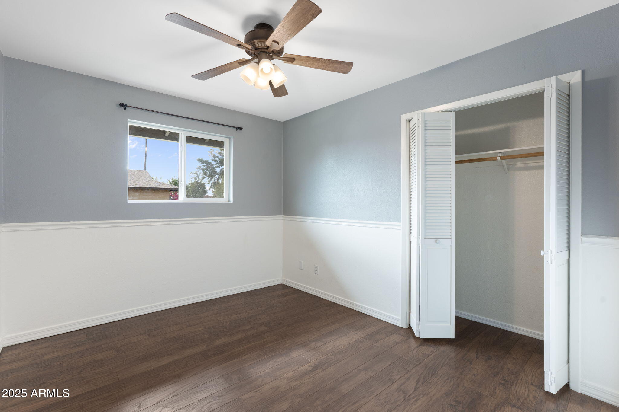 17 South Cholla Street Gilbert, AZ 85233 - Photo 28 of 37 an empty room with wooden floor chandelier fan and windows