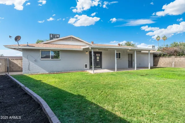 a front view of house with yard and outdoor seating