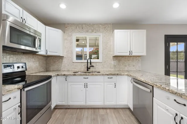 a kitchen with a refrigerator sink and microwave