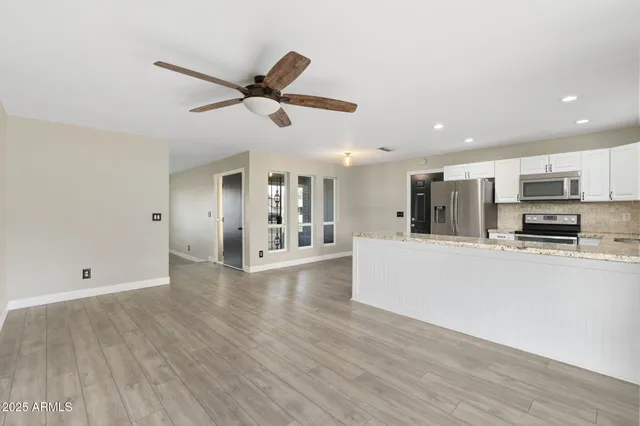 a spacious bathroom with a granite countertop sink mirror and