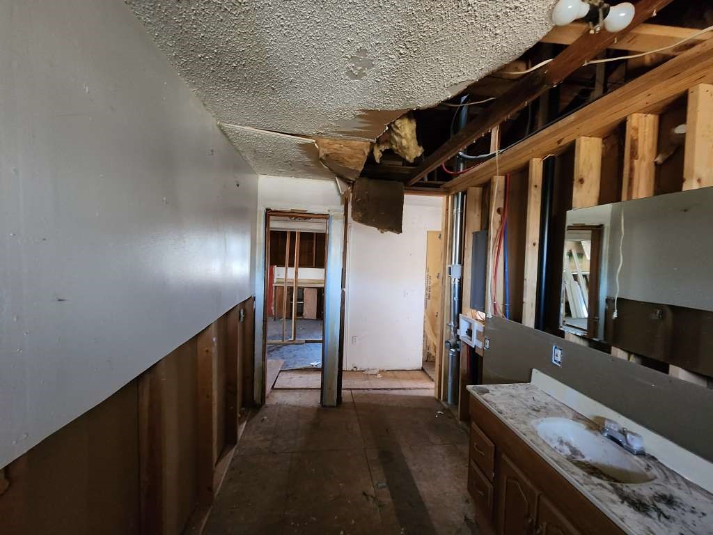 315 West Grand Street Borger, TX 79007 - Photo 14 of 19 a hallway with furniture and a stove