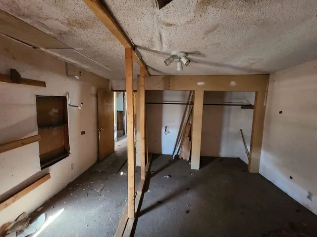 a view of a hallway with wooden walls and entryway