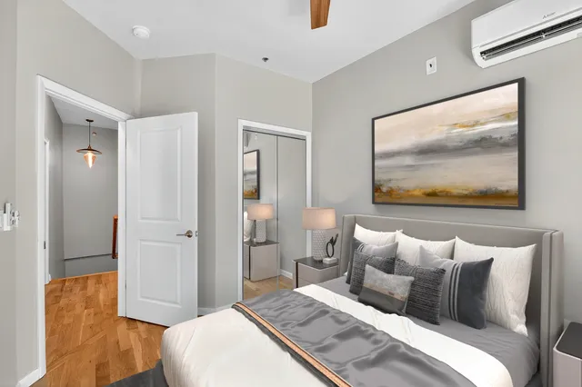 a bedroom with a bed and a painting on the wall