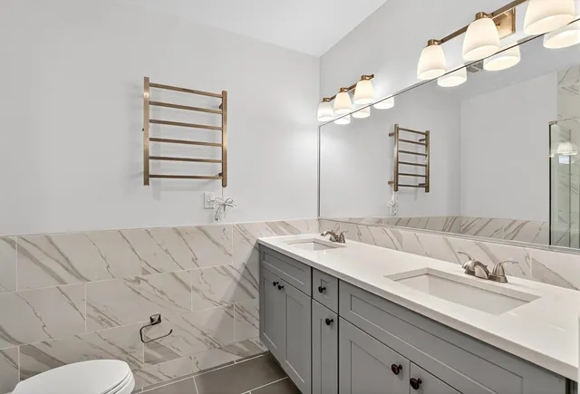 a bathroom with a sink double vanity and a mirror