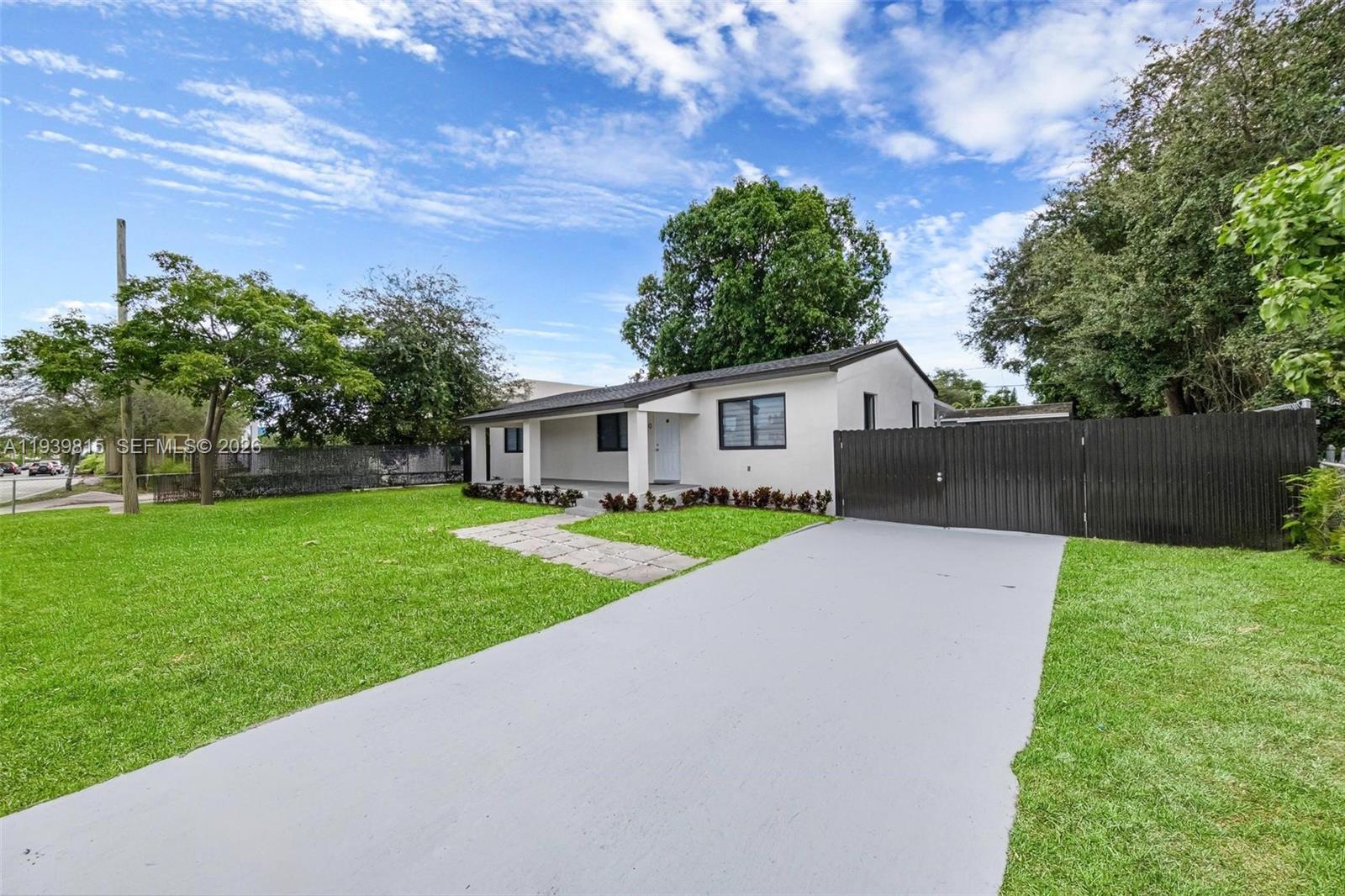 2250 Northwest 95th Street Miami, FL 33147 - Photo 2 of 26 a yellow and red house with a garden