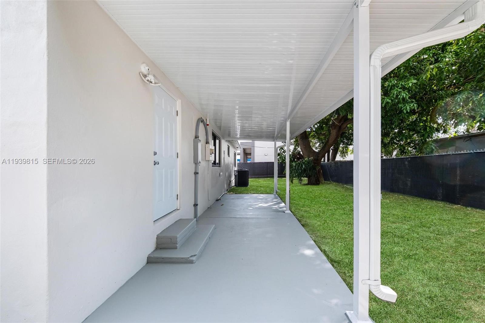 2250 Northwest 95th Street Miami, FL 33147 - Photo 23 of 26 a view of a porch with wooden walls and a yard
