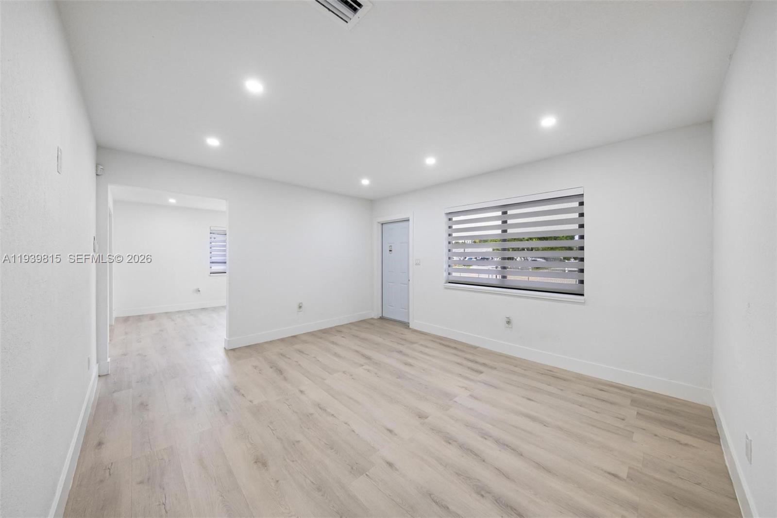 2250 Northwest 95th Street Miami, FL 33147 - Photo 6 of 26 an empty room with wooden floor and a window
