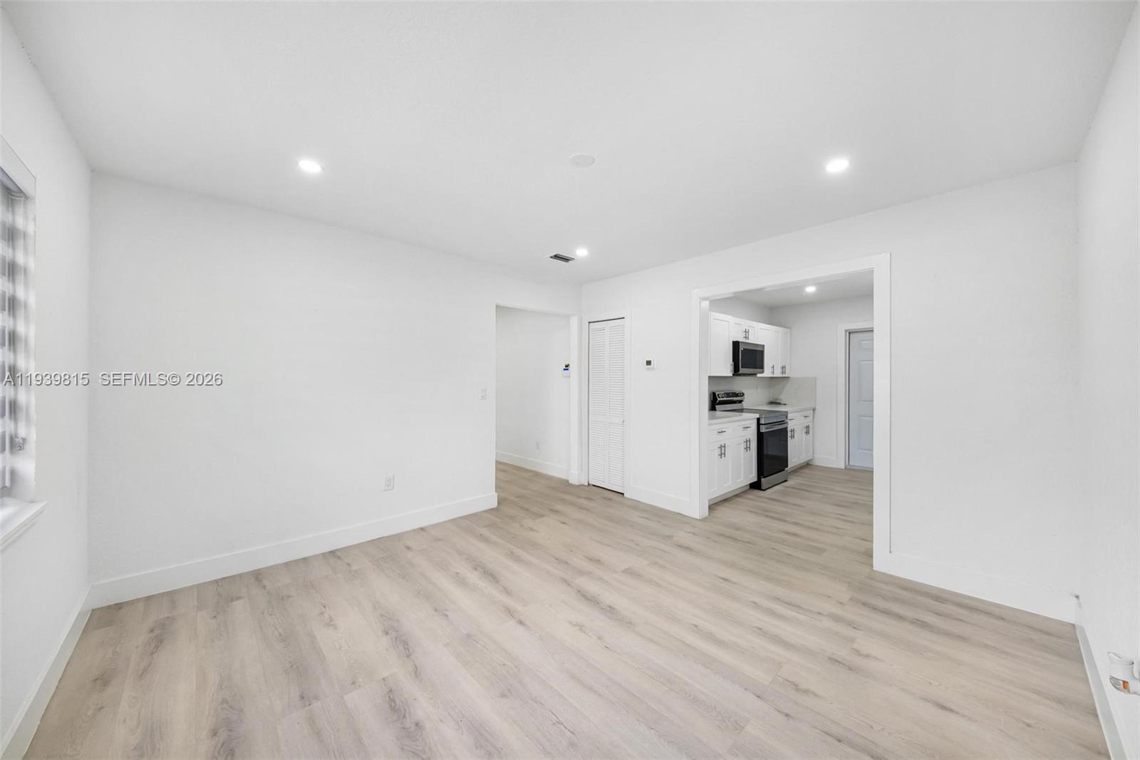 2250 Northwest 95th Street Miami, FL 33147 - Photo 8 of 26 a view of empty room with wooden floor