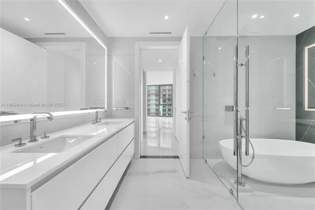 a bathroom with a double vanity sink mirror and shower