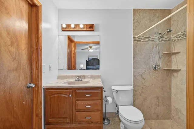 a bathroom with a sink a toilet and shower