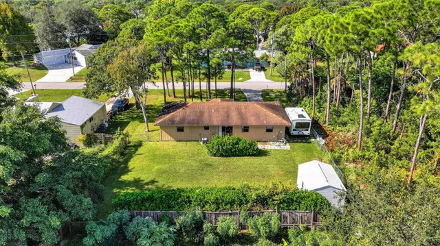 an aerial view of a house with yard and outdoor seating