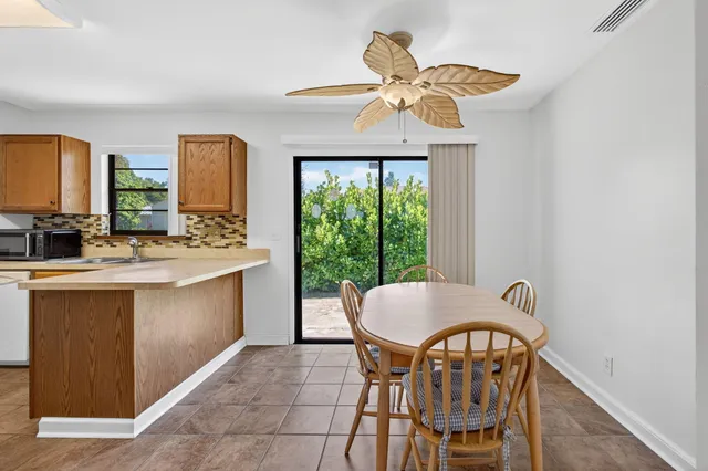 a view of a dining room with furniture window and outside view