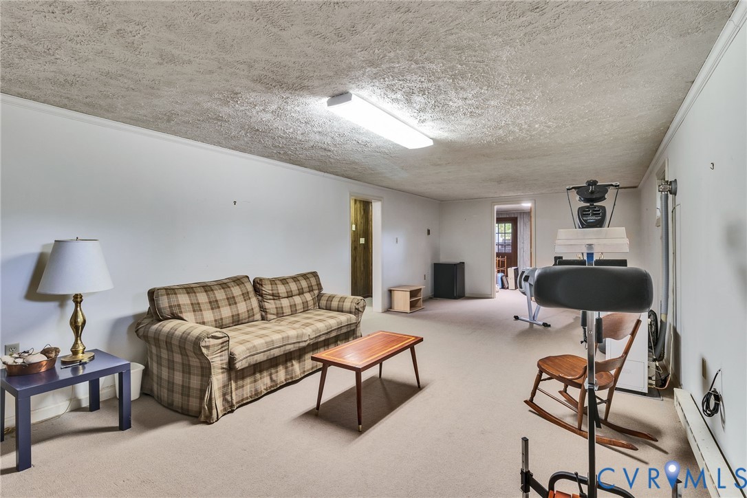 142 Bridge Lane Reedville, VA 22539 - Photo 20 of 56 a living room with furniture and a lamp
