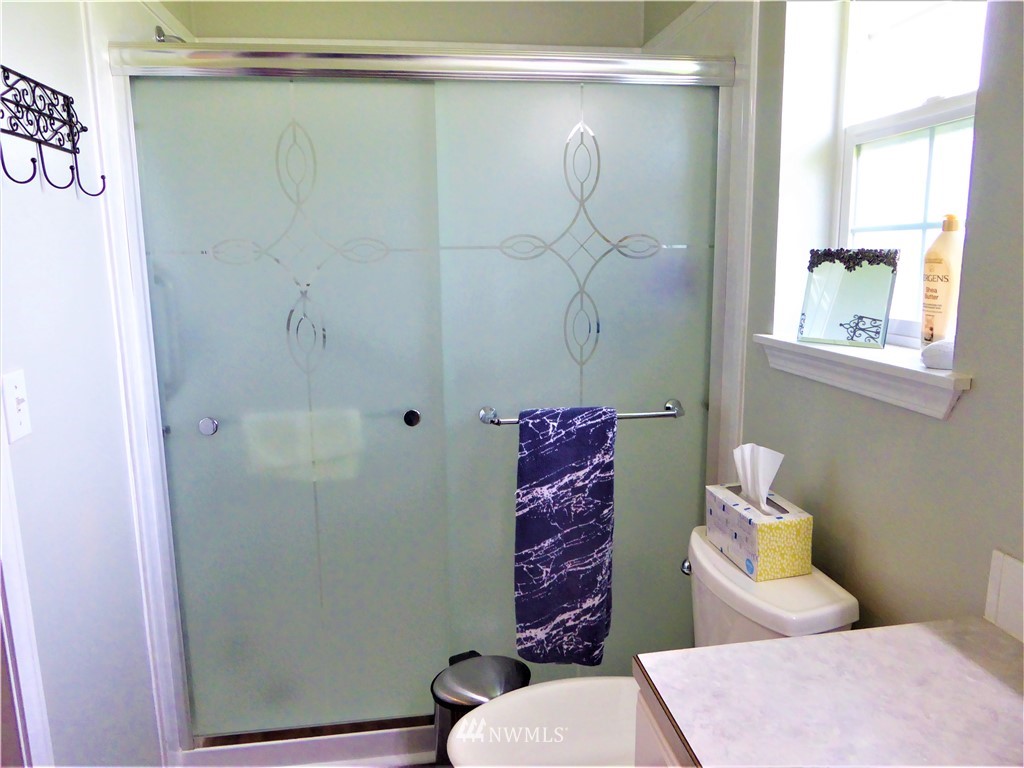 8637 194th Avenue Southwest Rochester, WA 98579 - Photo 23 of 37 a bathroom with a shower toilet and sink