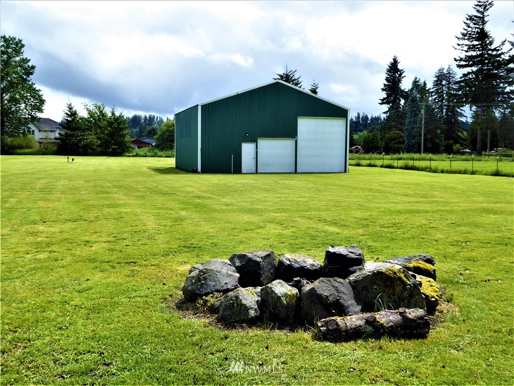 8637 194th Avenue Southwest Rochester, WA 98579 - Photo 26 of 37 a backyard of a house with lots of green space